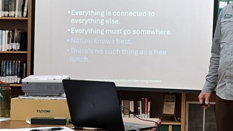 Man in library giving presentation