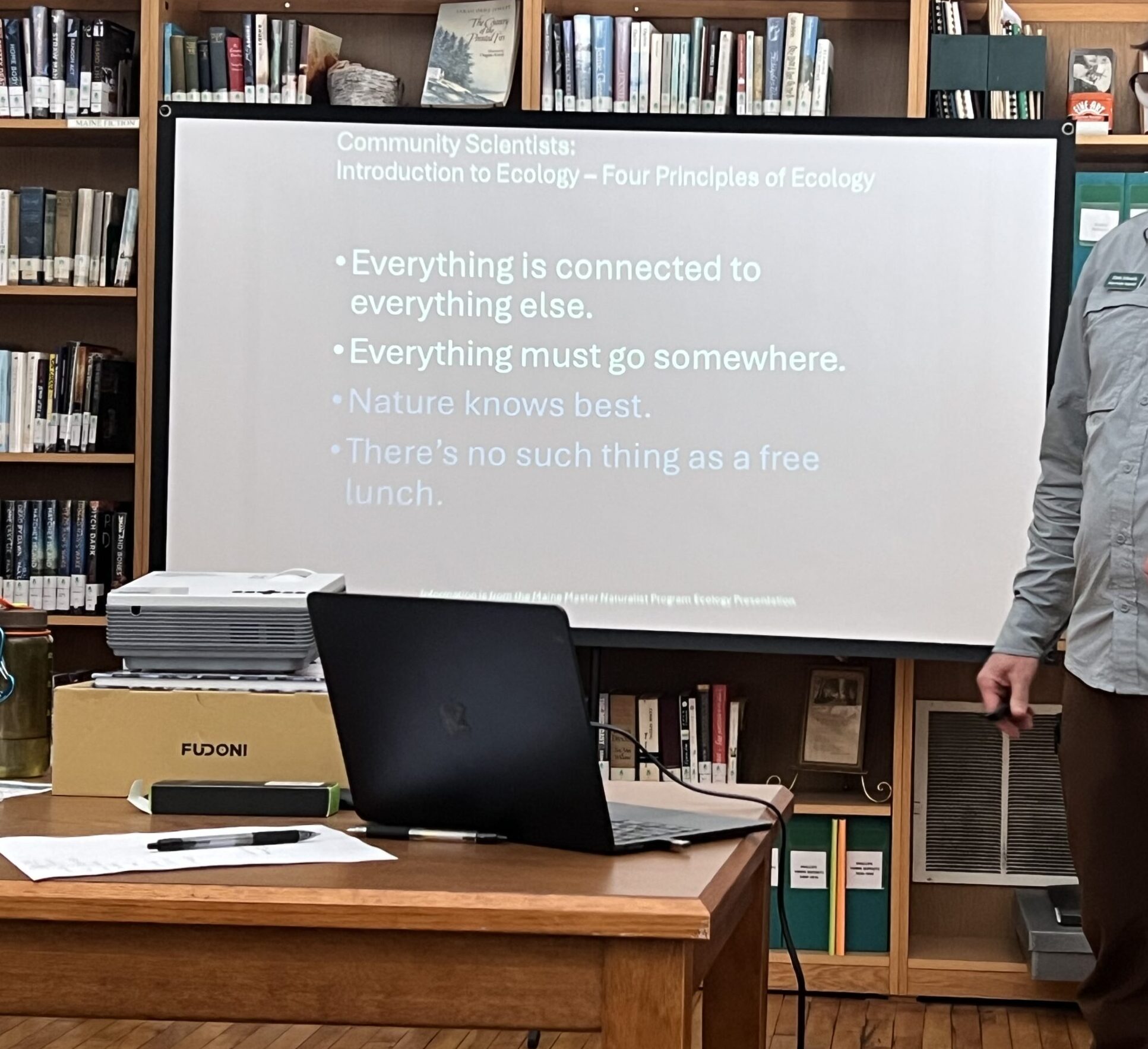 Man in library giving presentation